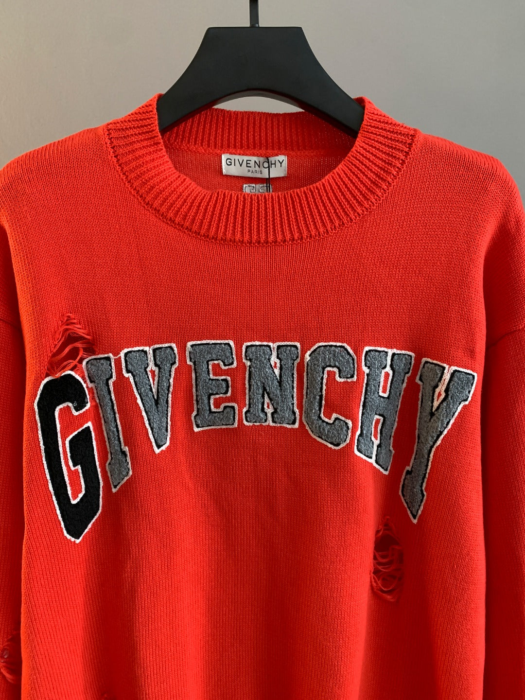 Givenchy red knit sweater with large GIVENCHY lettering on the front