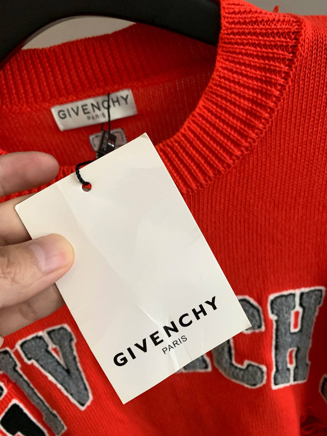 Givenchy red sweater neck tag with logo and Portugal-made details