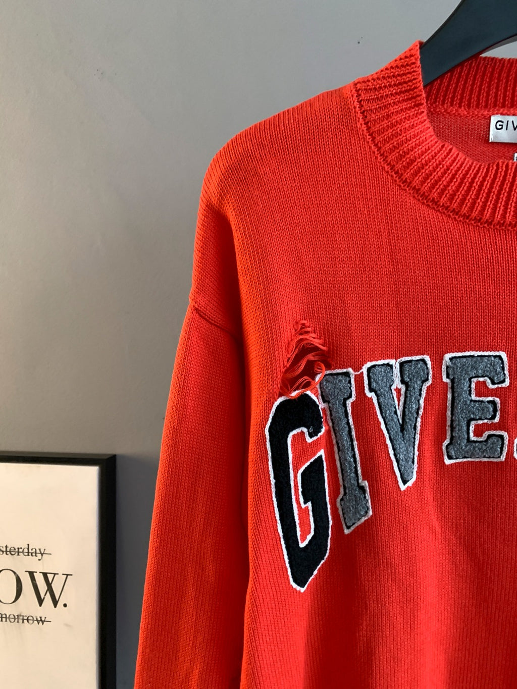 Givenchy red knit sweater sleeve with partial GIVENCHY graphic