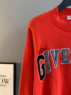 Givenchy red knit sweater sleeve with partial GIVENCHY graphic