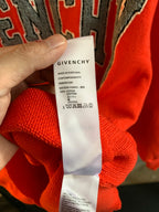 Givenchy red sweater care label with Made in Portugal and cotton blend info
