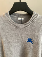 Heather gray knit sweater with ribbed crew neck, Burberry neck label, and blue horse