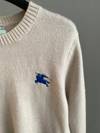 Cream knit long sweater with small blue horse logo on sleeve