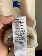Sweater care label close-up with washing and fabric composition symbols