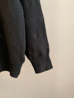Dark knit sweater sleeve cuff and hem with ribbed knit and LV monogram