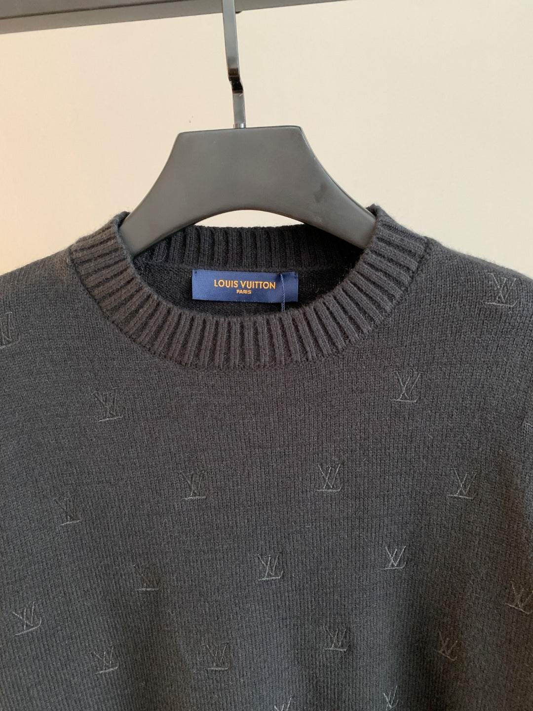Louis Vuitton knit sweater close-up: ribbed crew neck and LV monogram pattern