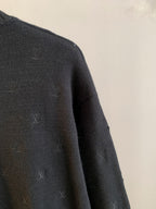 Dark knit sweater side with scattered LV monogram motifs, long sleeve