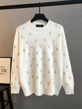 White knit sweater with gold Louis Vuitton monogram pattern, crew neck, long sleeves