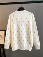 White knit sweater with gold Louis Vuitton monogram pattern, back view, crew neck