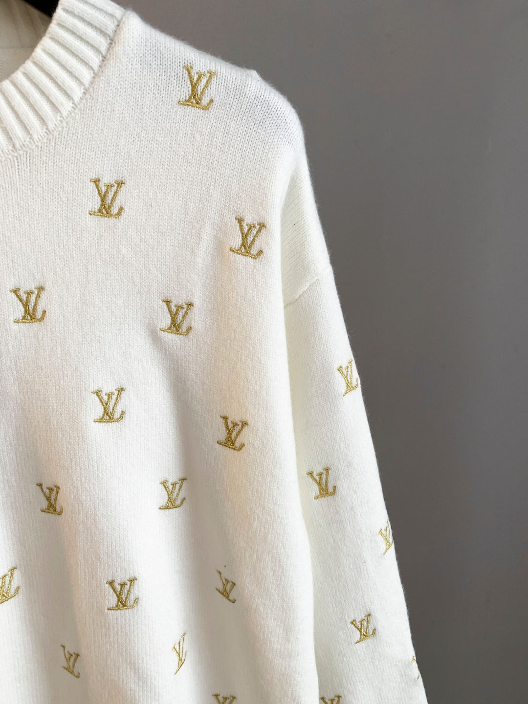 White knit sweater with gold Louis Vuitton monogram pattern, side sleeve detail