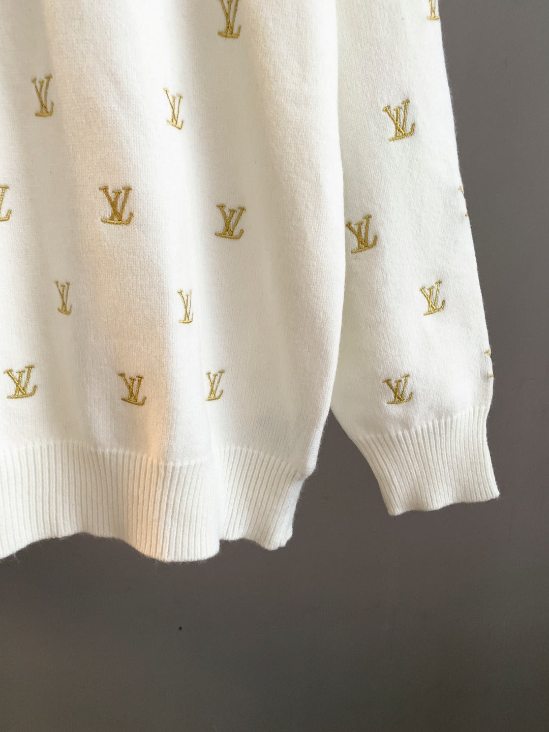 White knit sweater with gold Louis Vuitton monogram pattern, ribbed hem and cuffs