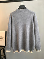 Gray knit sweater back view on hanger, crewneck with striped hem and cuffs