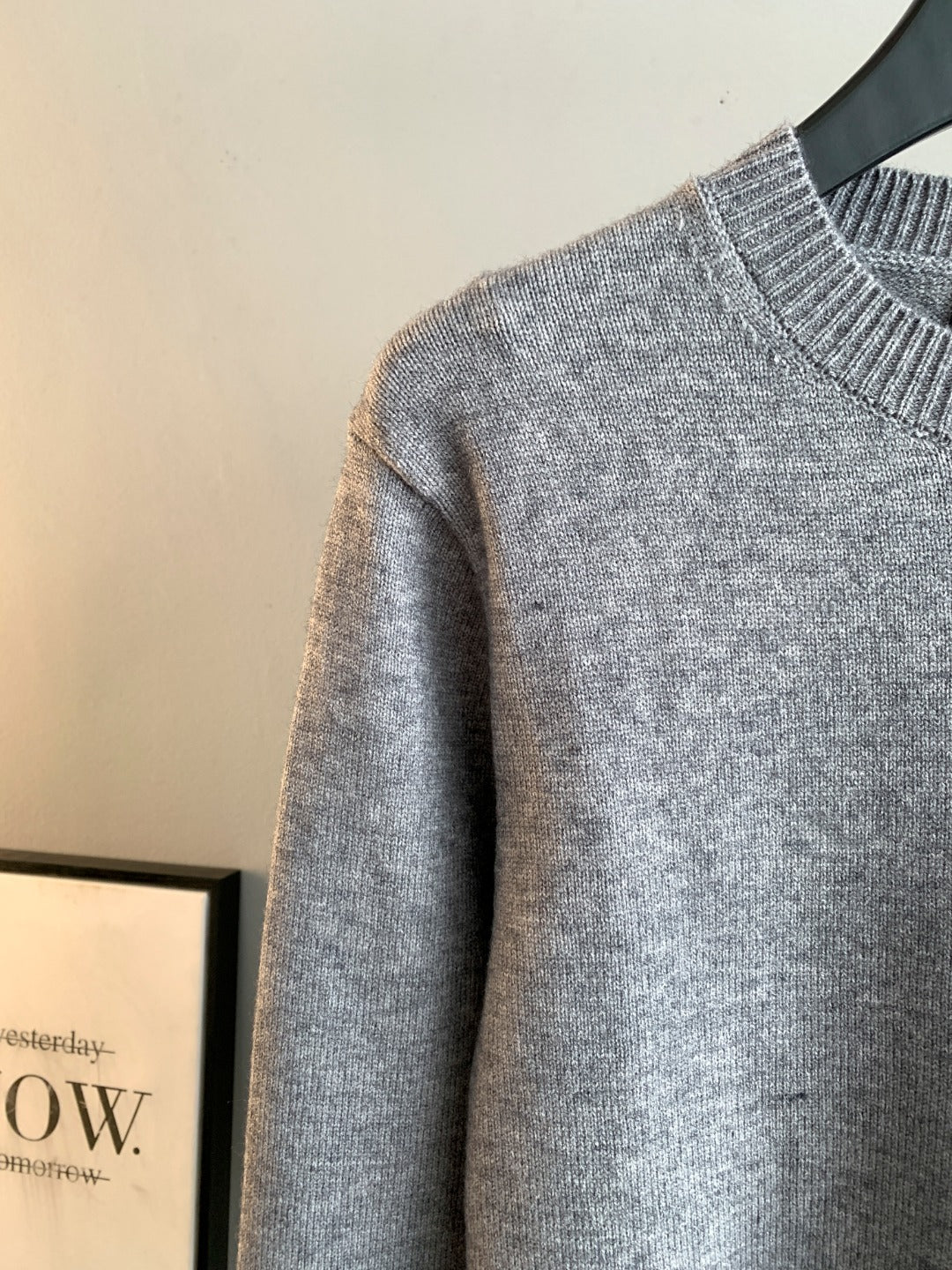Gray long-sleeve knit sweater side view with ribbed crewneck