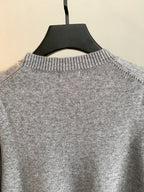 Gray knit sweater collar detail with ribbed crewneck on hanger