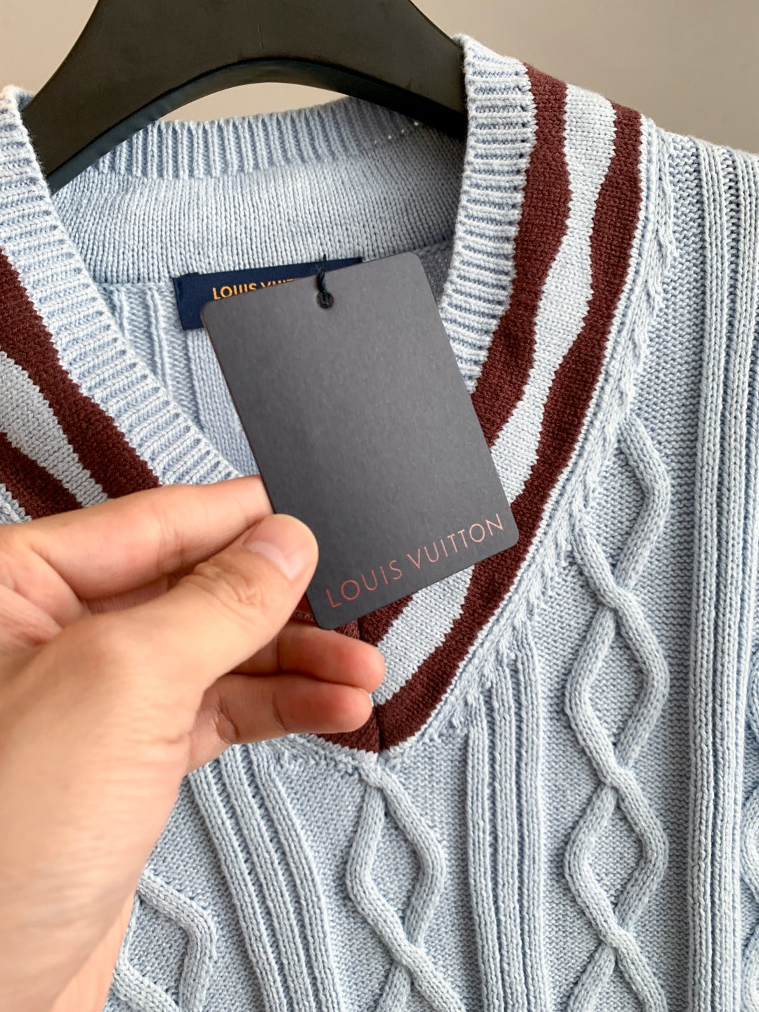 V-neck knit sweater detail with Louis Vuitton logo patch on the inner neck tag