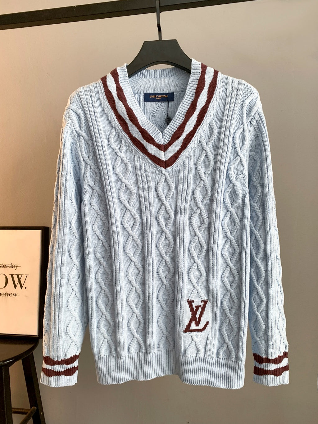 Long V-neck knit sweater in light blue with cable pattern and dark red trim, LV logo