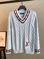 Long V-neck knit sweater in light blue with cable pattern and dark red trim, LV logo