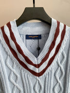 V-neck cable-knit sweater with light blue knit and dark red and white striped trim