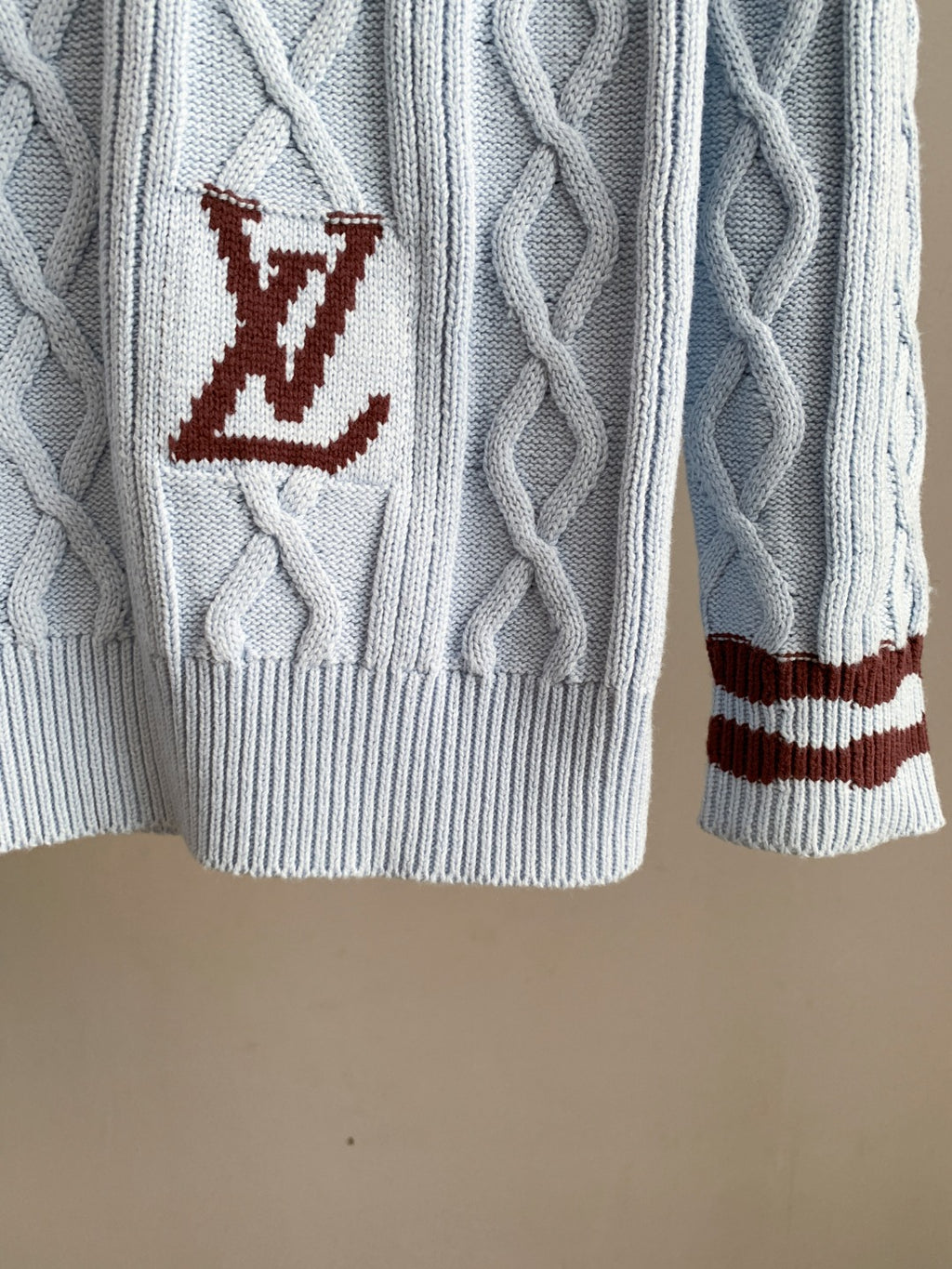Light blue cable-knit long sweater with burgundy LV logo patch on chest