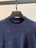 Dark navy knit sweater close-up of ribbed crew neck with Louis Vuitton logo patch