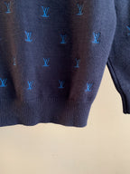Dark navy knit sweater lower back close-up with blue Louis Vuitton monogram pattern