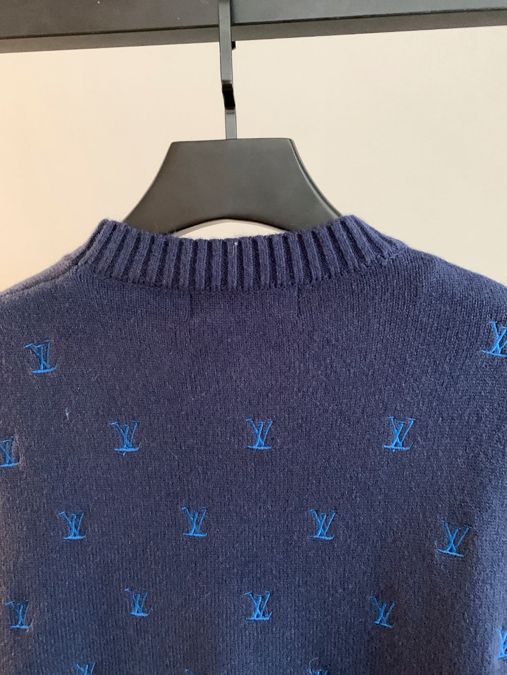 Dark navy knit sweater back close-up with blue Louis Vuitton monogram pattern