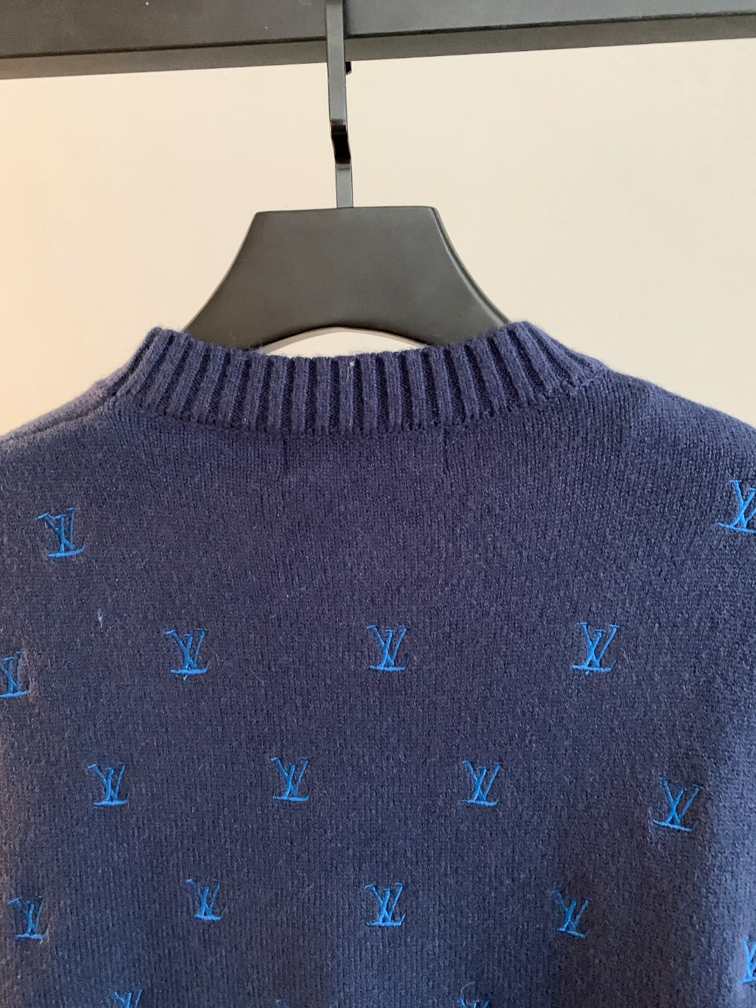 Dark navy knit sweater back close-up with blue Louis Vuitton monogram pattern