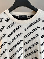 Crewneck sweater in cream with black BALENCIAGA logo pattern; ribbed neckline