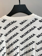Cream knit sweater with repeating Balenciaga logo pattern and ribbed crew neck