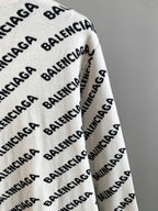 Long-sleeve sweater in cream with black BALENCIAGA logo pattern; side view