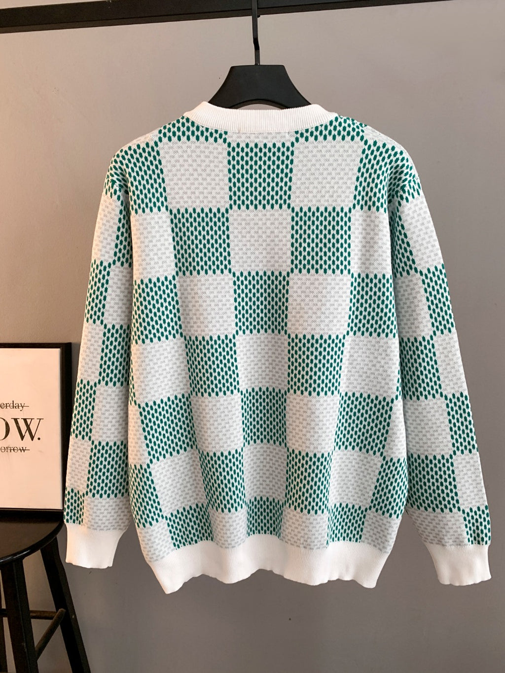 Long-sleeve knit sweater with green-and-white checkerboard pattern, ribbed cuffs and hem