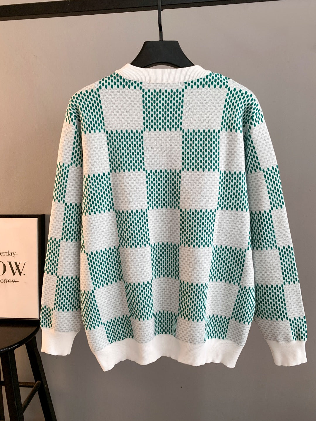 Long-sleeve knit sweater with green-and-white checkerboard pattern, ribbed cuffs and hem