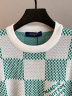 Long-sleeve knit sweater neckline with green-and-white check pattern, crew neck ribbing