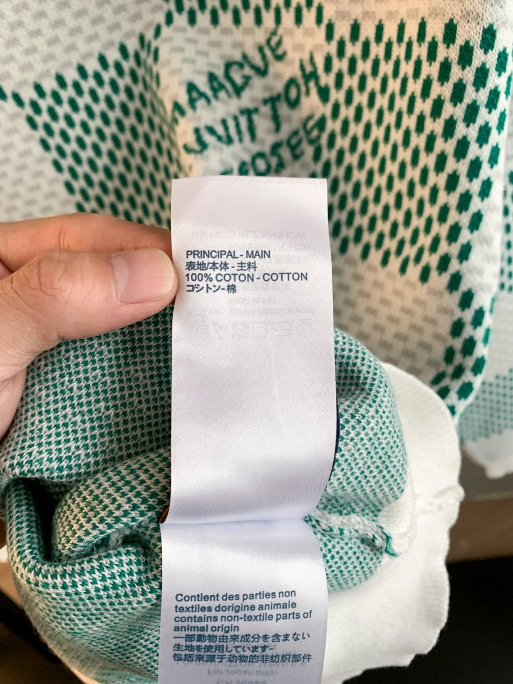 Inside neck label on cotton sweater showing '100% cotton' and care text