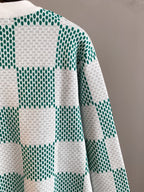 Side section of sweater with green-and-white check square knit pattern