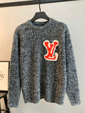 Louis Vuitton knit sweater speckled black/white with red LV graphic on chest
