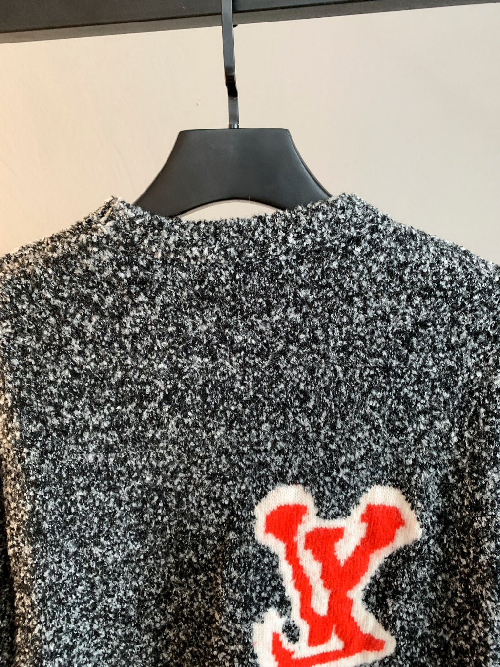 Louis Vuitton knit sweater back with speckled black/white knit and red LV logo