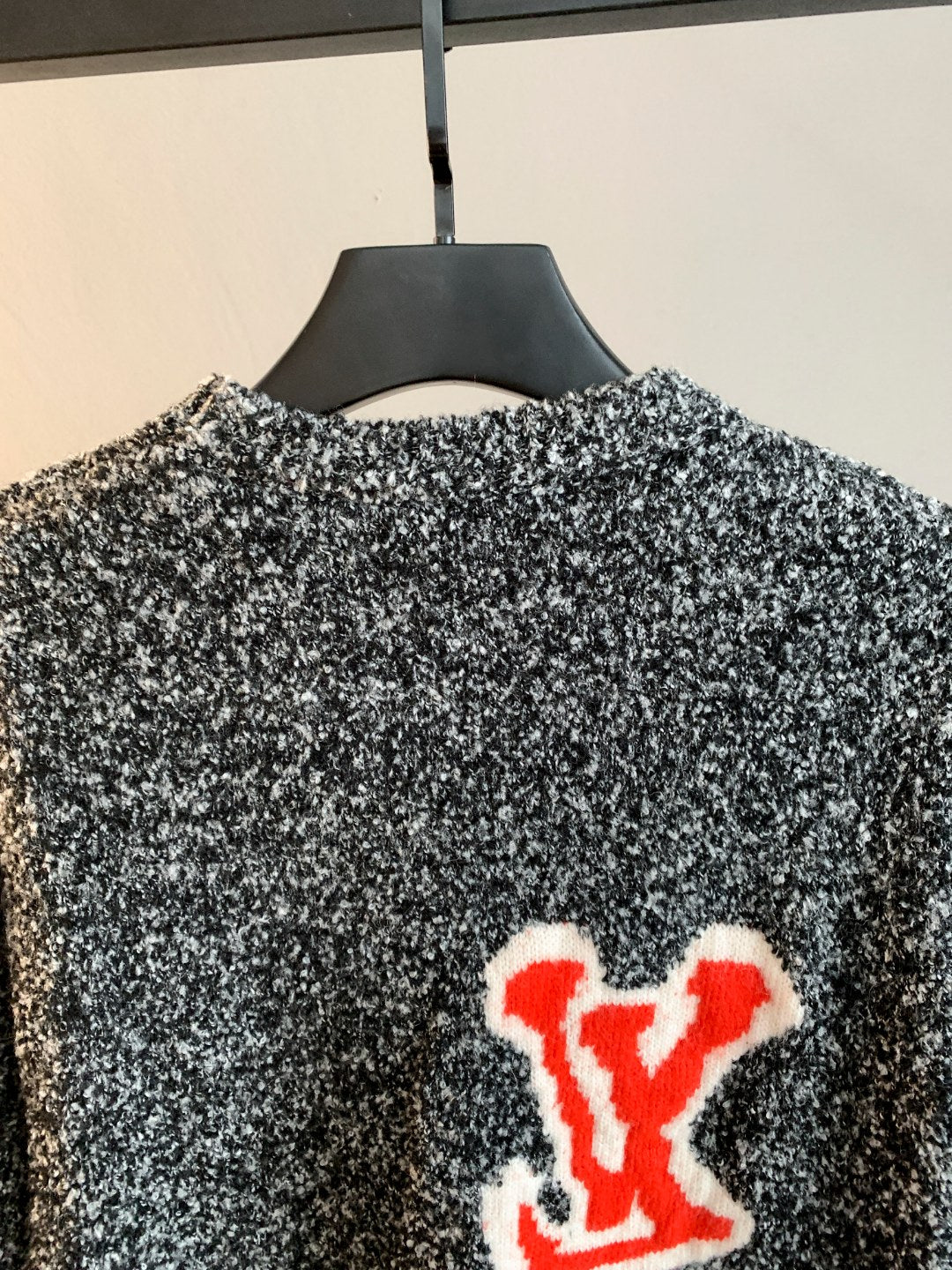 Louis Vuitton knit sweater back with speckled black/white knit and red LV logo