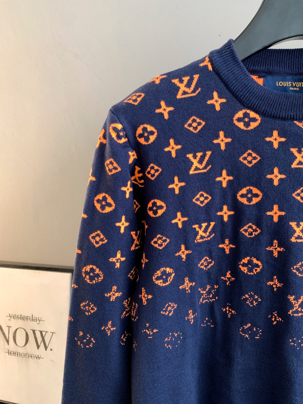 Louis Vuitton logo sweater side view in navy with orange monogram pattern