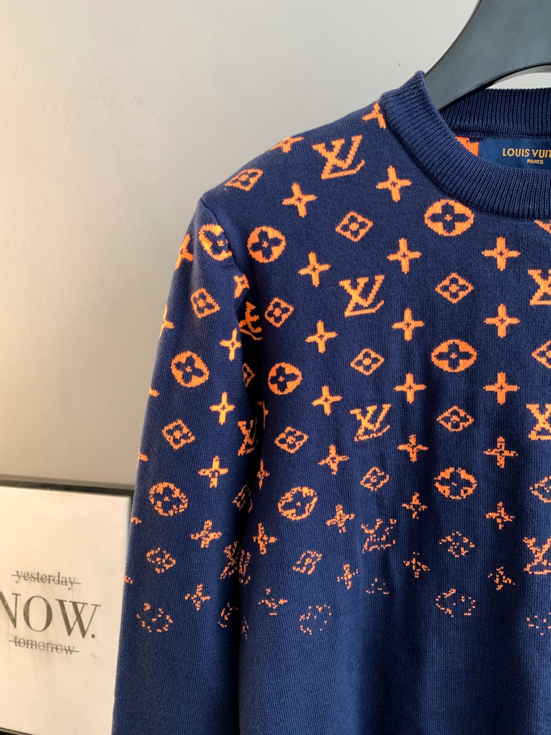 Louis Vuitton logo sweater side view in navy with orange monogram pattern