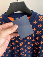Louis Vuitton logo sweater care label on navy fabric with orange monogram print