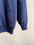 Navy ribbed knit cuffs and hem of long-sleeve sweater