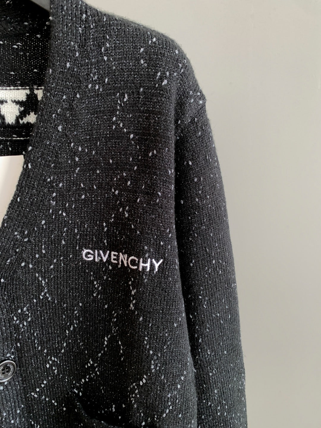 Black speckled cardigan with GIVENCHY logo embroidery on the chest.