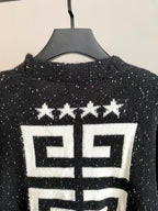 Black cardigan back close-up with white geometric logo and star motif.