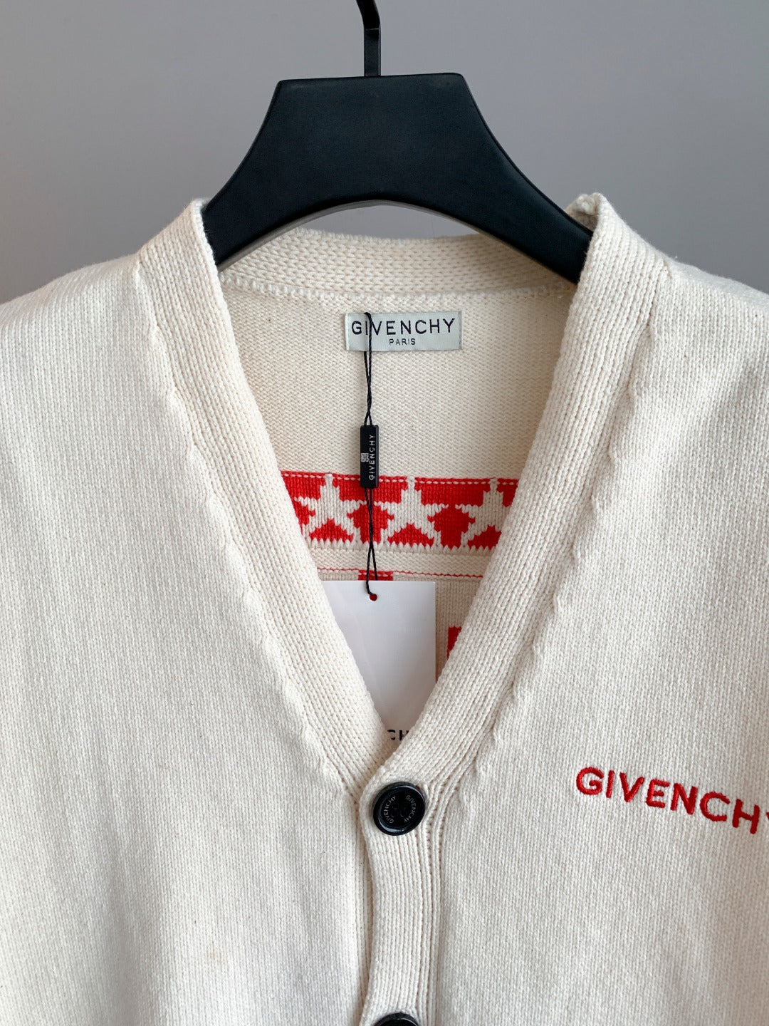 White knit cardigan V-neck with black button, red Givenchy logo stripe detail