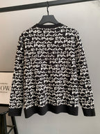 Black long-sleeve sweater with white repeating logo text; ribbed hem and crew neck
