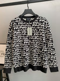 Black long-sleeve sweater with white repeating logo text; ribbed crew neck and cuffs