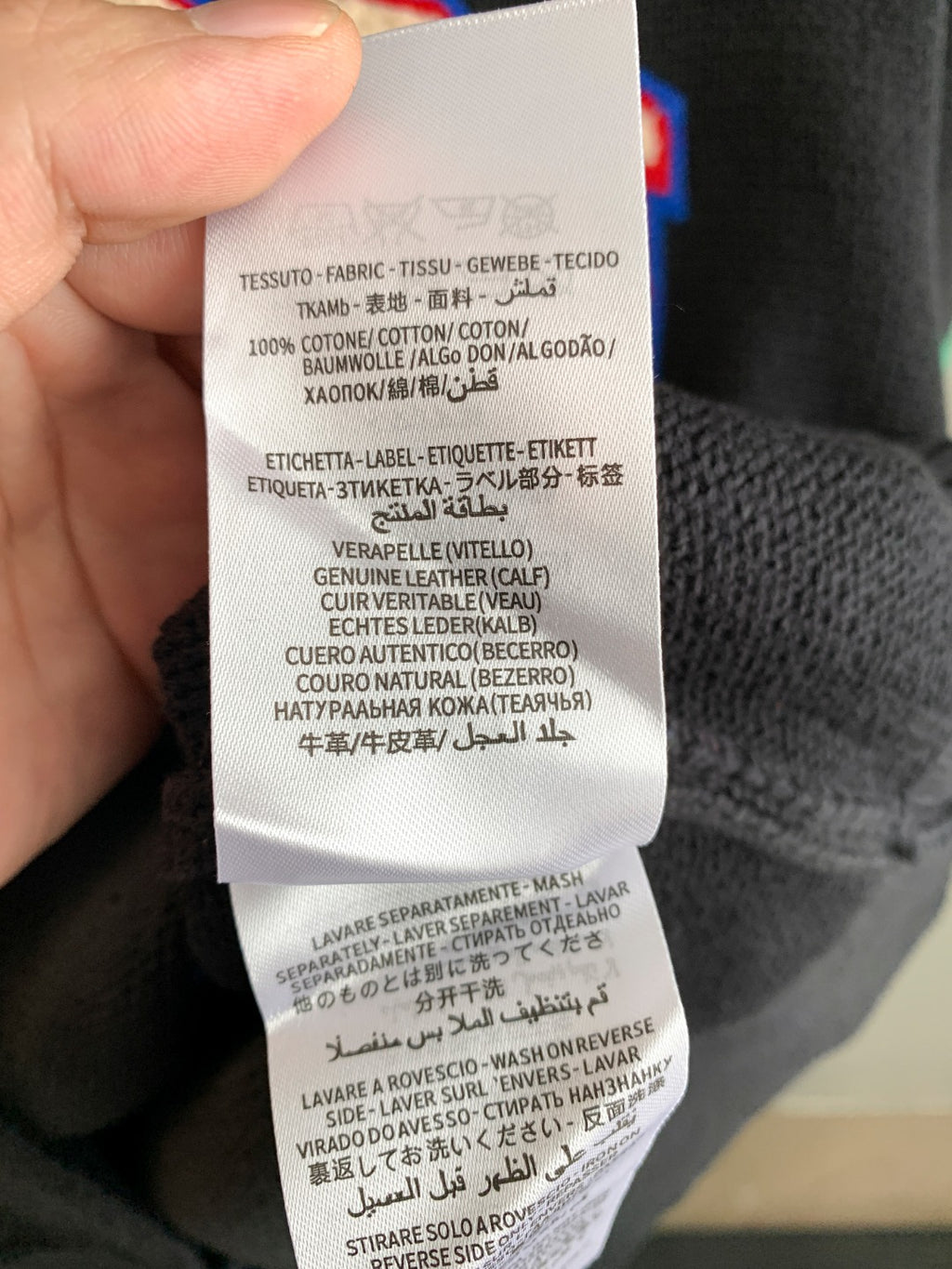 Gucci knit sweater care label close-up with washing and material instructions