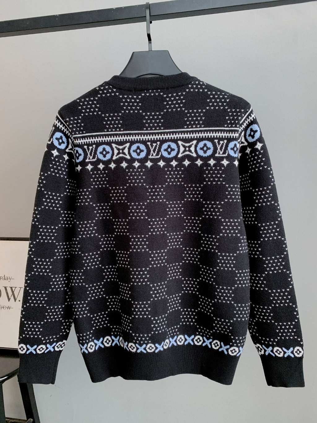 Back view crew-neck long-sleeve knit sweater in dark with repeating monogram bands