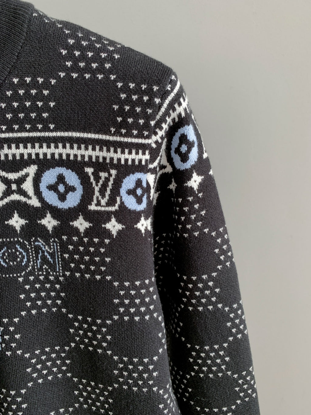 Side view long-sleeve knit sweater with white monogram band across sleeve
